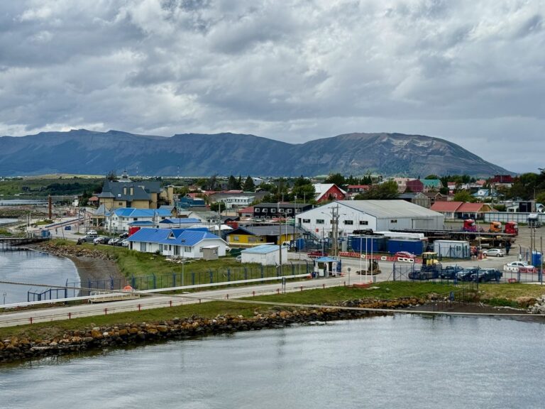 Puerto Natales waterfront and low-rise town beneath the mountains of Chilean Patagonia on a cloudy day