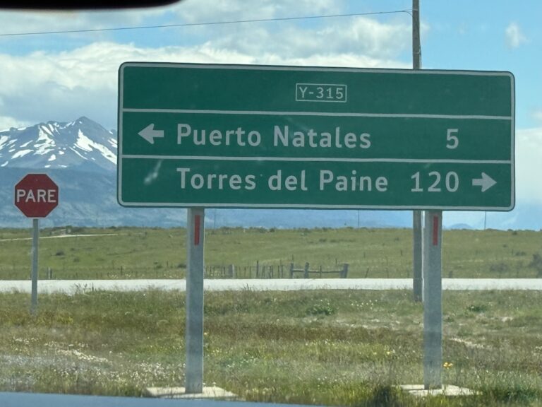 Route Y-315 sign showing Puerto Natales 5 km left and Torres del Paine 120 km right in Chilean Patagonia