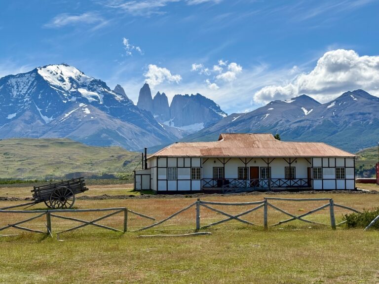 Traditional Patagonian ranch building and wooden cart at Estancia Laguna Amarga beneath the Torres del Paine mountains